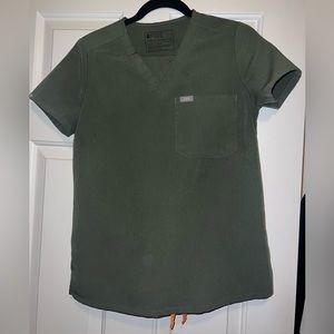 Moss colored The Catarina One-Pocket Scrub Top™ and Zamora Jogger Scrub Pants™